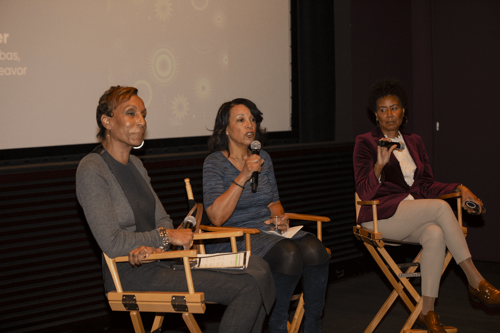 A different angle of the panel, capturing the expressions of the three speakers, each engaged in the conversation.