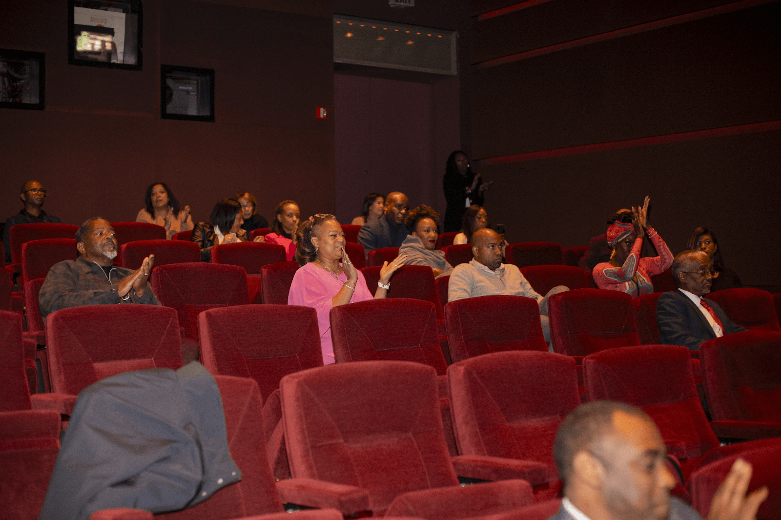 Audience members applauding and actively participating during the event, showcasing their enthusiasm.