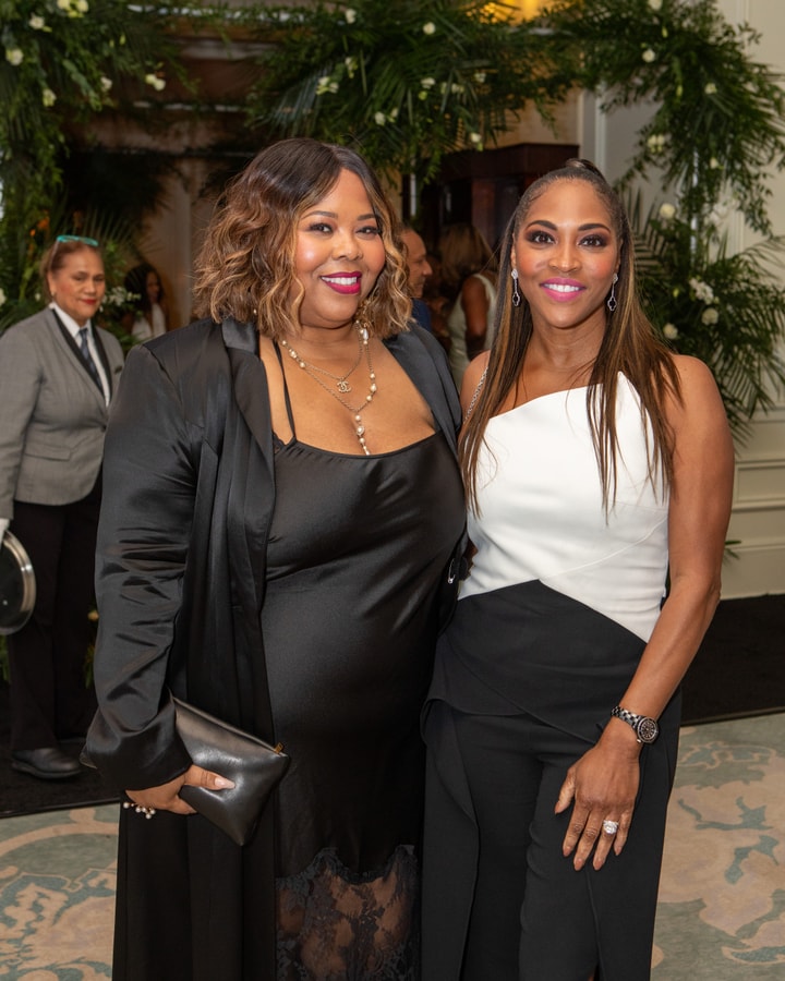Two women in elegant gala attire, posing together for a photo at a gala event