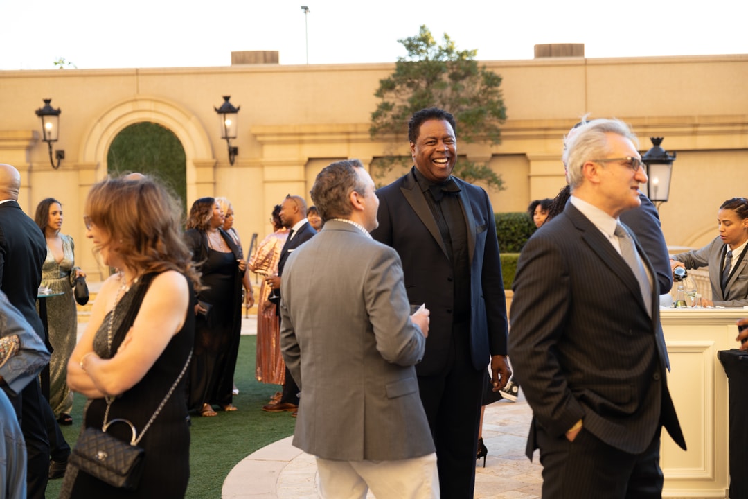 A group of BECA Gala attendees socializing outdoors.