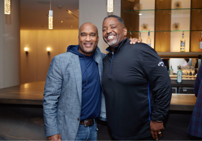 Two individuals smiling and networking