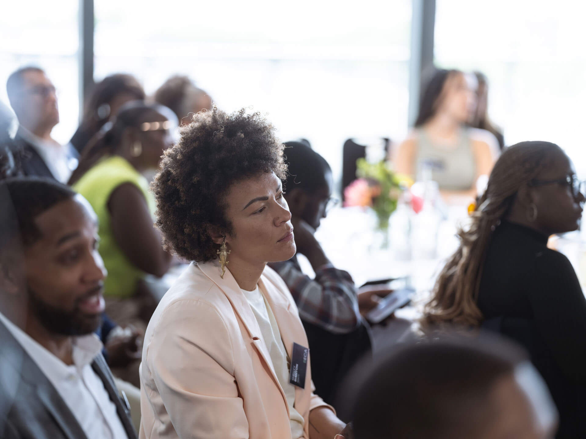 An audience member attentively listening during a professional event.