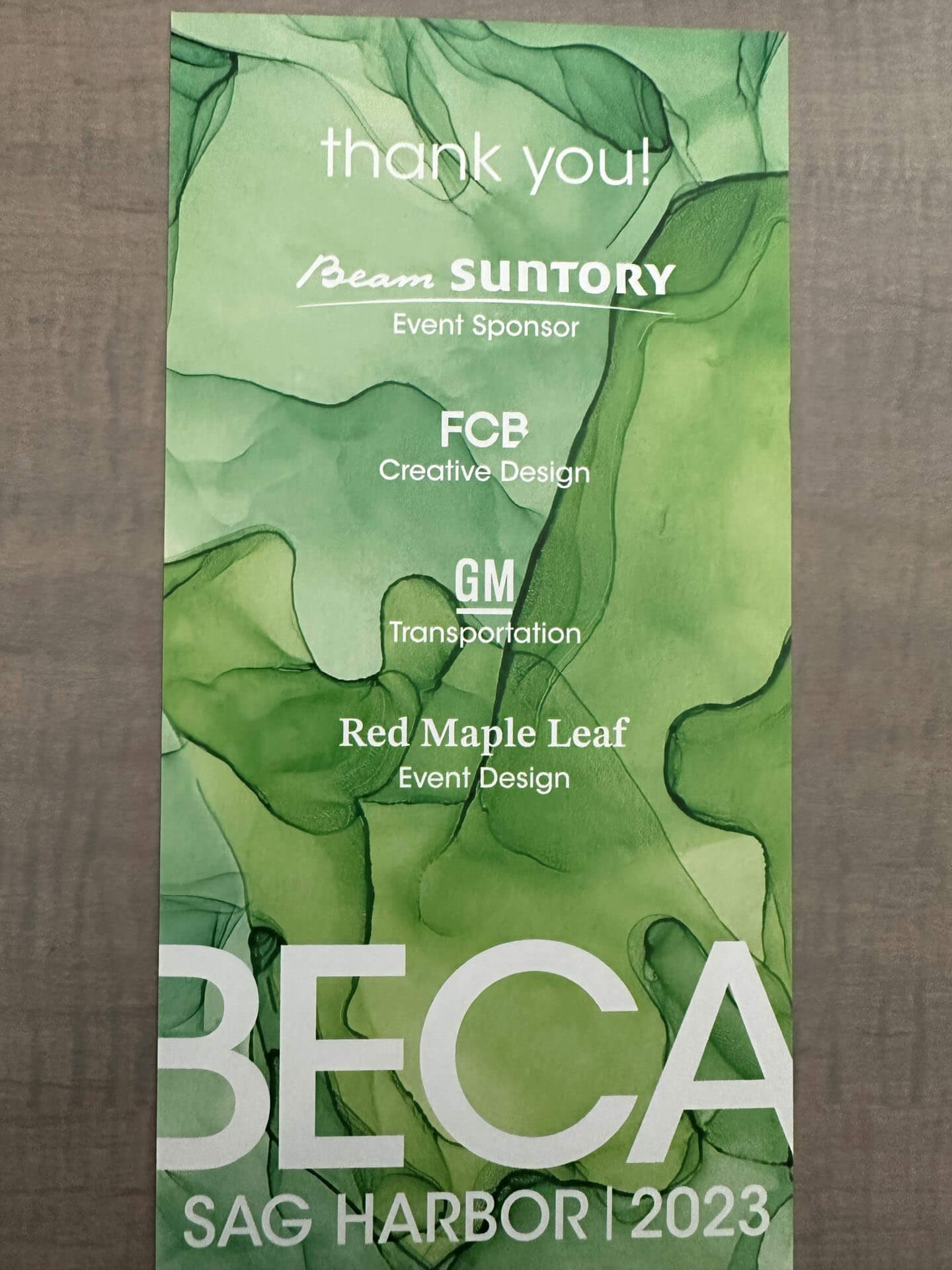 A flyer with a green background thanking event sponsors, including Beam Suntory, FCB, GM, and Red Maple Leaf, with "BECA Sag Harbor 2023" at the bottom.