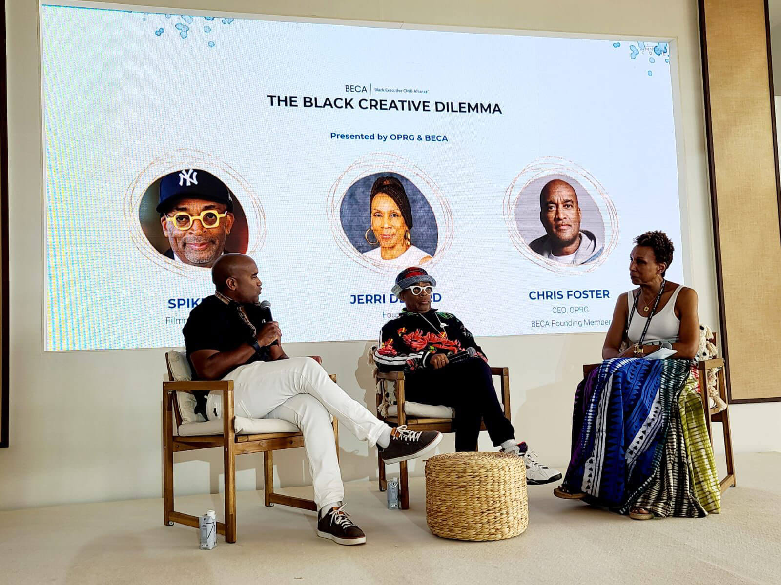 A discussion panel featuring notable speakers, including Spike Lee, under the event theme “The Black Creative Dilemma.”