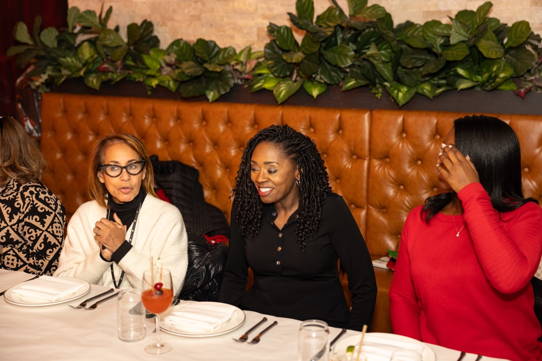 BECA Members seated at a table before dinner at the Brooklyn Chophouse.