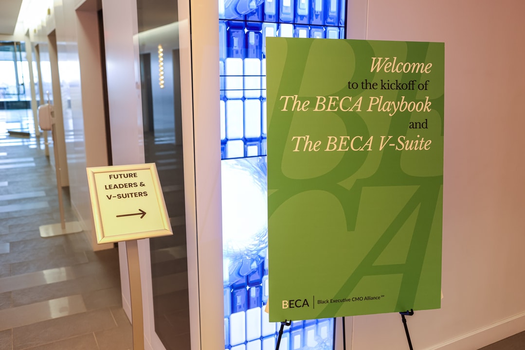 A sign reading "Welcome to the kickoff of The BECA Playbook and The BECA V-Suite"
