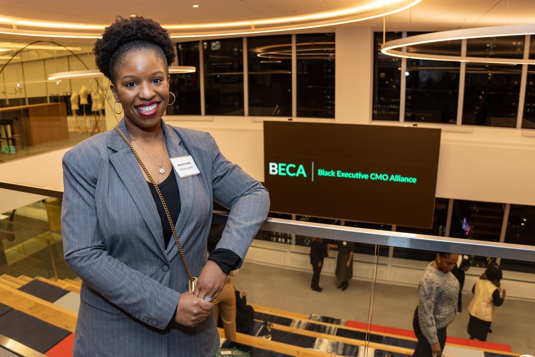 Future Leader Amanda Burks smiles in front of the BECA logo at Paramount Global HQ in NYC.