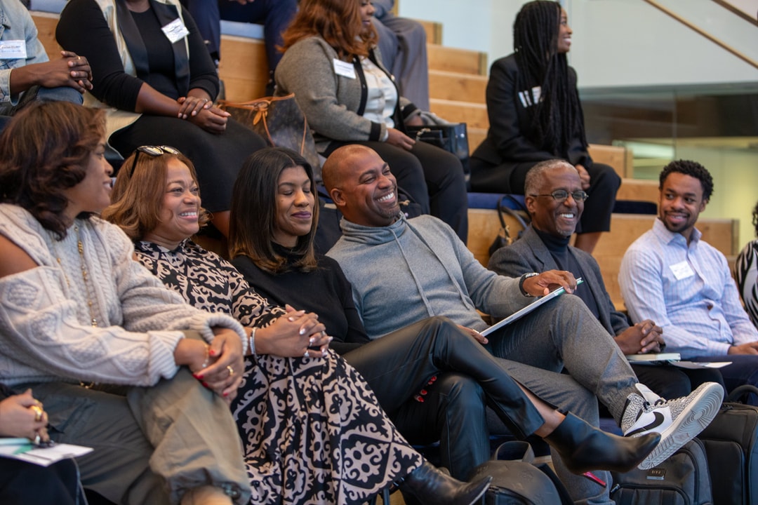 Participants laughing as they settle in for the BECA Playbook Kickoff.