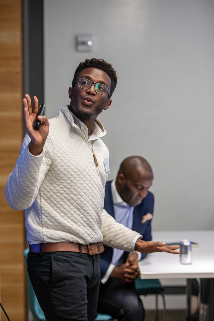 A man with glasses presenting to BECA Future Leaders.