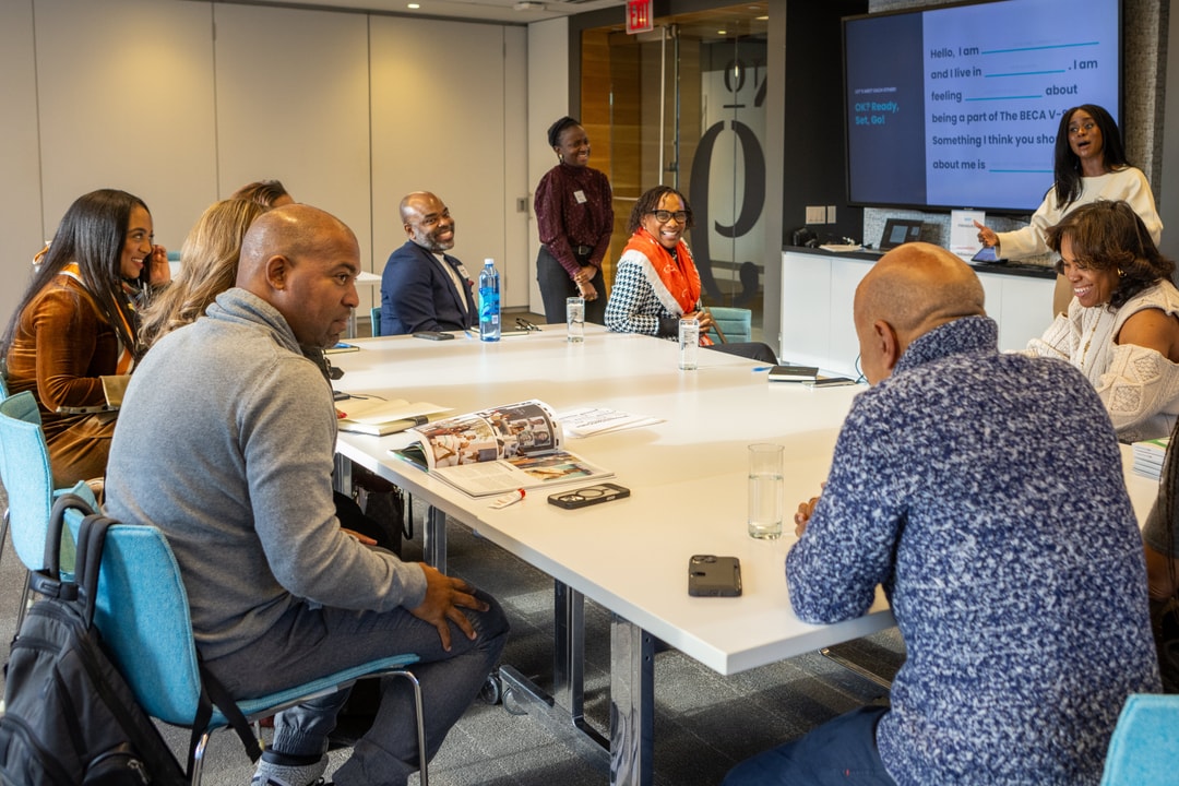 BECA V-Suite participants talk and laugh with BECA Members.